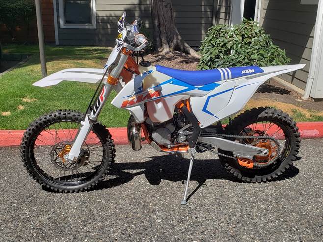 A motorcycle parked on a driveway

Description automatically generated
